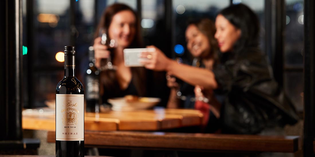 Three women drinking wine and taking a selfie. 